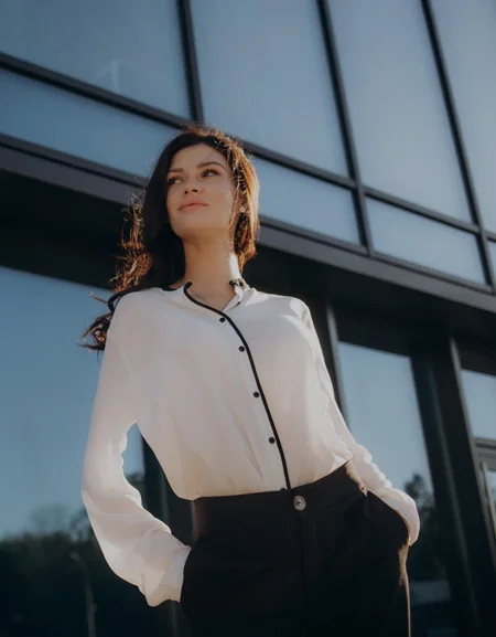 woman in white blouse standing in front of building in Bethesda, MD